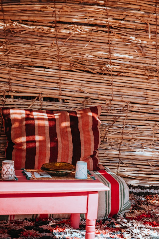 Vast golden sand dunes with soft curves shaped by the wind, stretching into the horizon beneath a bright sky, with ripples in the sand catching the light
